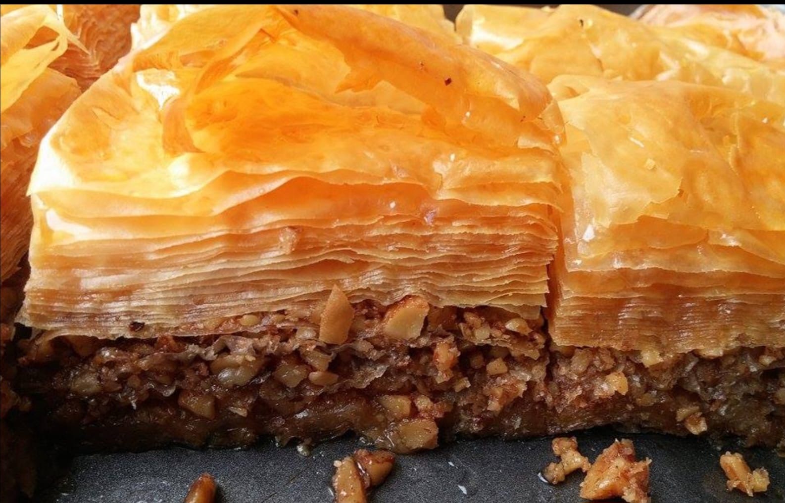 Close-up of freshly baked handmade baklava with layers of golden filo and walnuts